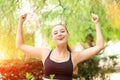 Winning, success concept. Beautiful, fitness sport girl rejoices in victory, raises her hands up. Royalty Free Stock Photo