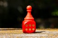 Winning, success simple abstract concept, single red toy game piece, chess pawn standing on the red board game dice showing six Royalty Free Stock Photo