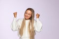 Winning, successful, lucky concept. Closeup portrait of happy woman in fluffy sweater, in studio