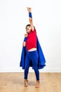 Winning super hero child playing with a powerful arm raised Royalty Free Stock Photo