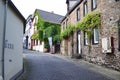 Winningen, Germany - 08 25 2023: Village street with vine at the houses