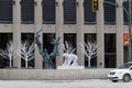 WINNIPEG, CANADA - 2014-11-17: Tree Children sculpture by Leo Mol surrounded by winter decorations in front of the