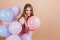 Winsome girl with bright makeup having fun at birthday party. Indoor photo of smiling gorgeous white woman with colorful Royalty Free Stock Photo