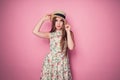 Winsome girl in romantic dress with flower print and straw hat p
