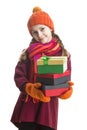 Winsome Happy Caucasian Little Girl In Orange Beanie Hat, twirling Scarf and Mittens With Pile of Colorful Giftboxes. Isolated Royalty Free Stock Photo