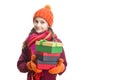 Winsome Happy Caucasian Little Girl In Orange Beanie Hat, twirling Scarf and Mittens With Pile of Colorful Giftboxes. Isolated Royalty Free Stock Photo