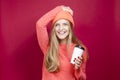 Winsome Positive Young Happy Emotional Cheerful Caucasian Girl Laughing In Knitted Autumn Hat and Sweater With Cup of Coffee on Royalty Free Stock Photo
