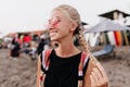 Winsome tanned girl posing with smile at beach. Outdoor portrait of blonde woman in pink glasses pl Royalty Free Stock Photo