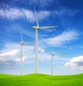 Wint turbines oh green hill and blue sky. Alternative source of energy