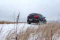 Winter adventure offroad car in nature while traveling around country in cold snowy weather