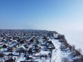 Winter aerial view of a snow-covered village near the river Royalty Free Stock Photo