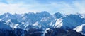 Winter alpine mountain range under a blue sky