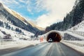 Winter alpine road landscape with tunnel, forest, mountains and blue sky on background at bright cold sunny day. Car Royalty Free Stock Photo