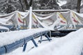 Roller coaster cowered with snow in amusement park in winter Royalty Free Stock Photo