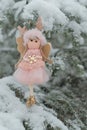 Winter angel on a snowy tree. Snow fairy.Christmas and New Years time.Christmas tree toy.