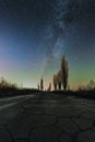 Winter astronomical landscape. Milky Way over the broken asphalted road Royalty Free Stock Photo