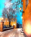 Winter aTallinn old town street vintage lanterb street light snowy trees and house medieval city Royalty Free Stock Photo