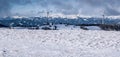 Winter austrian alps panorama with wind turbines and snow covered peaks