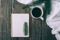 Winter and autumn composition. Top view of vintage notebook with fir tree and pencil, decorated with cup of coffee