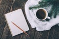 Winter and autumn composition. Top view of vintage notebook with fir tree and pencil, decorated with cup of coffee