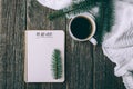 Winter and autumn composition. Top view of vintage notebook with fir tree and pencil, decorated with cup of coffee