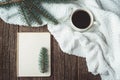 Winter and autumn composition. Top view of vintage notebook with fir tree and pencil, decorated with cup of coffee