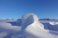 Winter background. Abstract. Snow drifts on the background of blue clear sky, smooth transitions of lines of light and shadow. Royalty Free Stock Photo