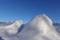 Winter background. Abstract. Snow drifts on the background of blue clear sky, smooth transitions of lines of light and shadow. Royalty Free Stock Photo