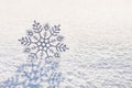 Winter background with beautiful silver snowflake on whiteness snow surface. Merry Christmas and Happy New year greeting cards