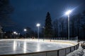 Winter background with empty lit ice rink and spotlights Royalty Free Stock Photo