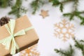 Winter background with gift box, fir branches and snowflakes.