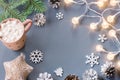 Winter background with hot drink with marshmallows, Christmas lights, fir tree and decorations. Copy space Royalty Free Stock Photo