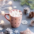 Winter background with hot drink with marshmallows, Christmas lights, fir tree and decorations. Royalty Free Stock Photo