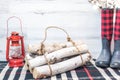 Winter background - logs, boots and lantern Royalty Free Stock Photo
