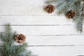 Winter background with pine branches, cones, white wood copy space , celebration card, seasonal holiday