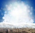 Winter background with snow and blur abstract lights. Empty wooden plank. Copyspace for text Royalty Free Stock Photo