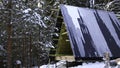 Winter background with snow. Clip. A beautiful landscape in the forest with a wooden hut under construction. Royalty Free Stock Photo