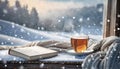 Winter background. tea cup, book, sweater and winter frozen window. cozy mood, home comfort in snowy cold weather Royalty Free Stock Photo