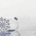 Winter background with transparent glass ball and silver snowflakes on whiteness snow surface. Merry Christmas and Happy New year Royalty Free Stock Photo