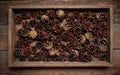 Winter background with wooden crate full of cones on the wooden background