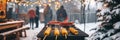 Winter backyard barbecue: grilled corn and festive atmosphere with string lights Royalty Free Stock Photo