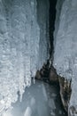 Winter Baikal. Olkhon Island. Ice grotto. Thick blue ice and icicles on the coastal rocks of Olkhon Island in winter Royalty Free Stock Photo