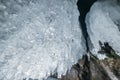 Winter Baikal. Olkhon Island. Ice grotto. Thick blue ice and icicles on the coastal rocks of Olkhon Island in winter Royalty Free Stock Photo