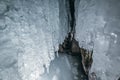 Winter Baikal. Olkhon Island. Ice grotto. Thick blue ice and icicles on the coastal rocks of Olkhon Island in winter Royalty Free Stock Photo