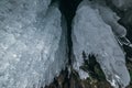 Winter Baikal. Olkhon Island. Ice grotto. Thick blue ice and icicles on the coastal rocks of Olkhon Island in winter Royalty Free Stock Photo