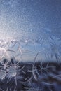 Winter background. Frozen window in winter time. Frost pattern on the window. Icy flowers on a glass Royalty Free Stock Photo