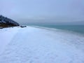 Winter beach covered with thick snow and ice.