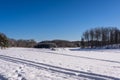 Winter beautiful landscape. Ski tracks or trails in the fresh snow. Amazing panoramic view of forest woods against blue sky and wh Royalty Free Stock Photo