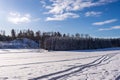 Winter beautiful landscape. Ski tracks or trails in the fresh snow. Amazing panoramic view of forest woods against blue sky and wh Royalty Free Stock Photo