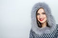 Winter beauty fashion. Beautiful face girl with trendy fur hat gesturing. Emotions. Professional makeup and manicure. Portrait on